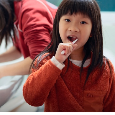 little girl brushing her teeth